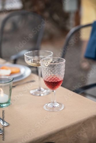 Empty wine glasses on an outdoor dinner table