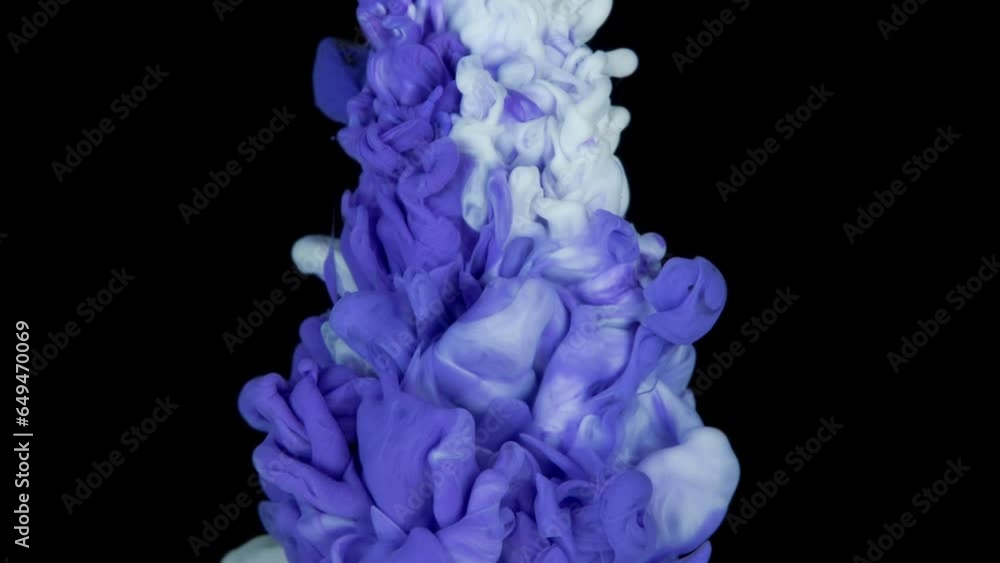 Blue white ink paint top view blending in the water in slow motion. Ink liquid underwater on black background. blue abstraction Blue white ink paint top view blending in the water in slow motion. Ink liquid underwater on black background. blue abstraction