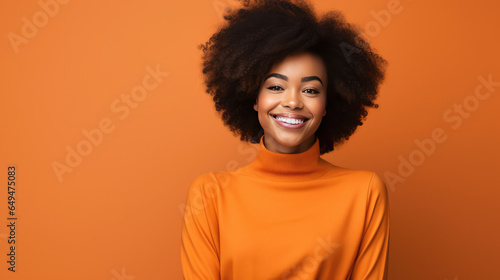 Stunning African American model in vibrant orange attire, radiating positivity against a matching background. Ideal for fashion, social media, advertising, and corporate promotion.