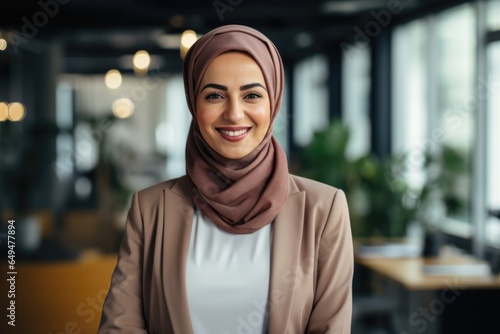 Smiling portrait of a happy arabic senior woman working in a modern business office for a startup company