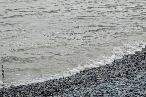 View of the shore of the turtle beach, sea waves, small waves and stones. Located in Casma, Ancash - Peru