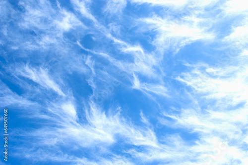 White Cirrus uncinus clouds against blue sly photo