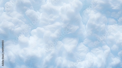 Fluffy, white cotton cloud texture background, capturing the soft, billowy appearance of cotton candy clouds in a blue sky. Great for dreamy and whimsical design concepts.