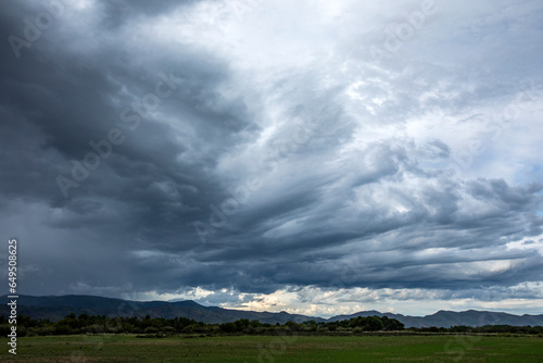 USA, Idaho, Bellevue, Storm clouds above landscape with meadow