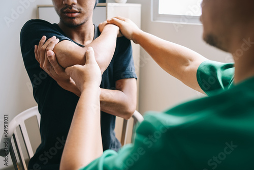 Photography Physical therapist examines elbow pain and checking patient elbow at the clinic office room