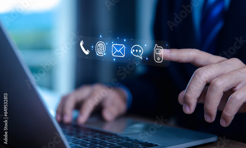 Bild auf Leinwand businessman using a laptop to contact customer support shows a contact icon ( address, phone, email, mobile, call ) contact us concept