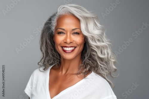 Beautiful gorgeous 50yo mid age beautiful elderly senior woman with grey hair laughing and smiling. Mature old lady close up portrait. Healthy face skin care beauty, skincare cosmetics, dental.