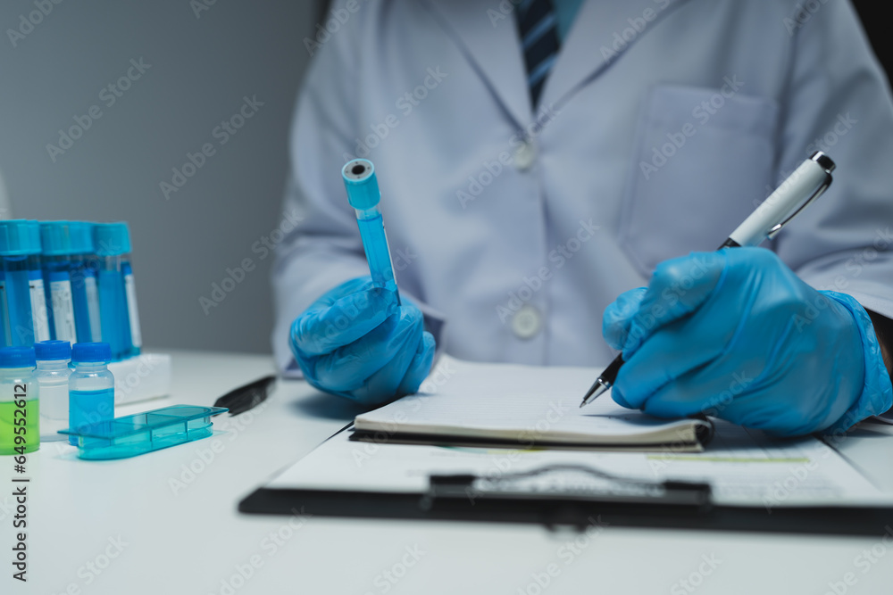 medical research laboratory Asian male scientist working using digital tablet analyze the sample record biochemical data medical science laboratory development of microbiology advanced equipment. medical research laboratory Asian male scientist working using digital tablet analyze the sample record biochemical data medical science laboratory development of microbiology advanced equipment.
