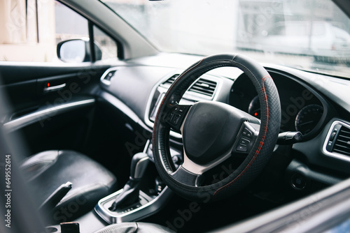 Car interior. Steering wheel, shift lever and dashboard. © Gatot