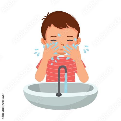 Cute little boy washing face in the sink