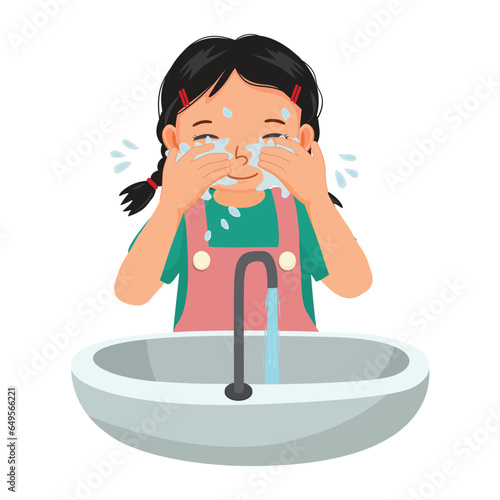Cute little girl washing face in the sink