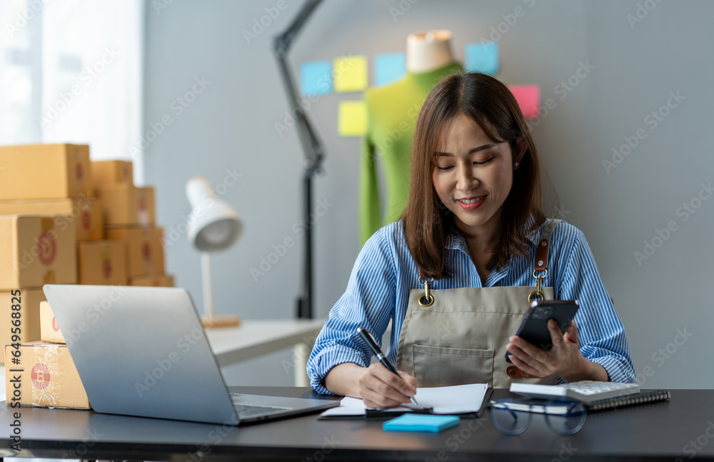 Small business start-up, SME owner, female entrepreneur working on packaging parcels. Receipt and check orders online to prepare boxes for sale to customers, online SME business concept. Small business start-up, SME owner, female entrepreneur working on packaging parcels. Receipt and check orders online to prepare boxes for sale to customers, online SME business concept.
