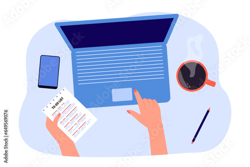Employee working on computer from home vector illustration. Organized workspace with laptop, smartphone, coffee cup, hand holding to-do list and tapping on laptop. Self-employment, technology concept