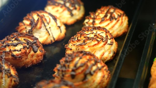 Coconut macaroons drizzled with chocolate at a bakery photo