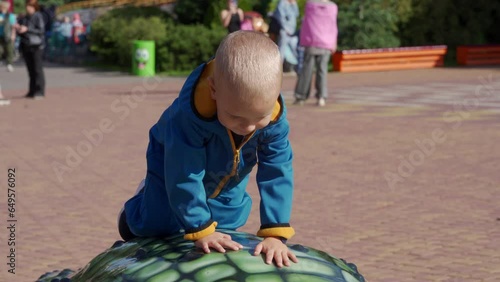 toddler child in amusement park Divo Ostrov, St. Petersburg, Russia photo