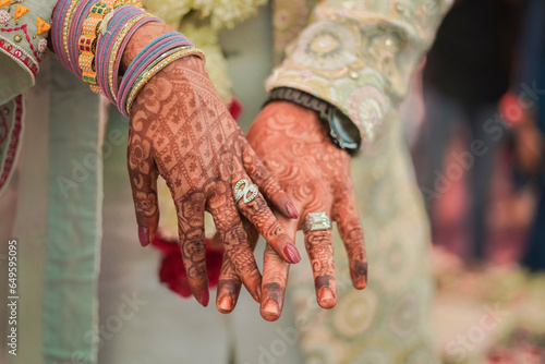 Bild auf Leinwand Indian groom and bride hand in hand showing ring