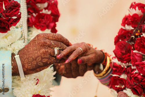 фотографія Indian groom and bride hand in hand showing ring