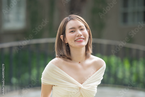 Portrait of young smiling woman looking at camera. happy girl standing in creative office. casual smiling laughing lifestyle of single female, natural look healthy skin and perfect teeth.
