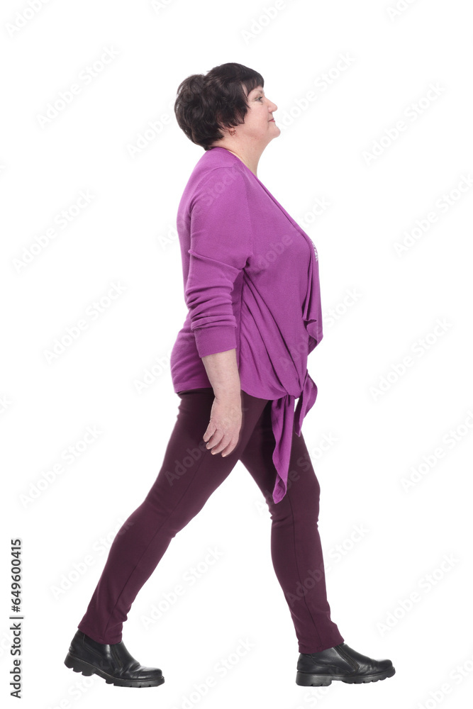 Fototapeta premium casual elderly woman in a purple blouse striding forward.