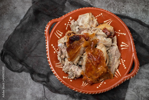 crispy tasty baked piglet in ceramic dish photo