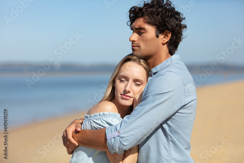 romantic couple embracing at the beach