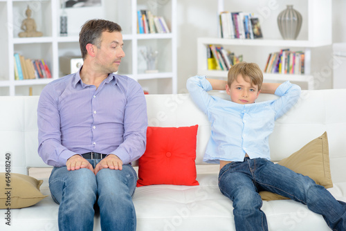 фотографія Father and son sitting separately