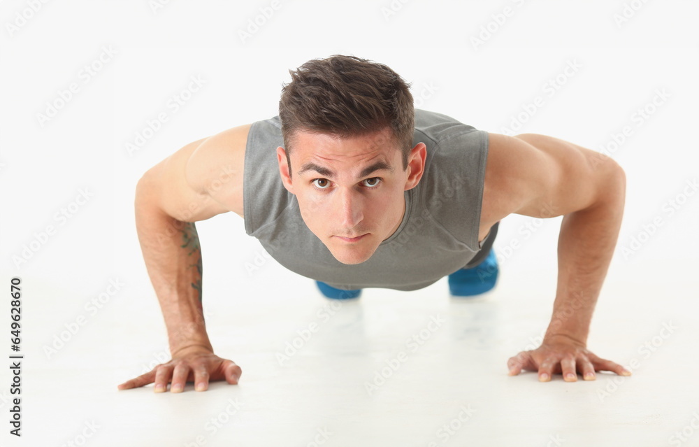 Fitness man wringing from the floor demonstrates good physical exercises isolated on white background. Healthy lifestyle for many people exercising their own weight for losing for every day push up. Fitness man wringing from the floor demonstrates good physical exercises isolated on white background. Healthy lifestyle for many people exercising their own weight for losing for every day push up.