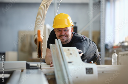 Worker using electric saw portrait. Manual job workplace DIY inspiration improvement fix shop yellow helmet hard hat joinery startup idea industrial education profession career concept photo