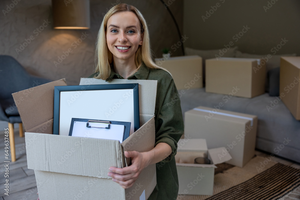 Smiling blonde woman with a box in hands Smiling blonde woman with a box in hands