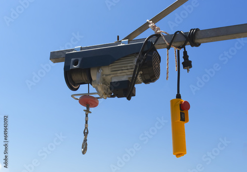 Electrical hoist on the  metal beam photo