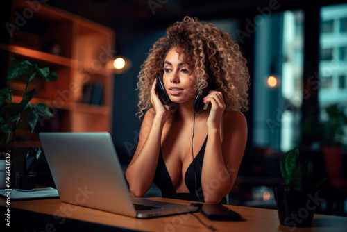 Sensual Woman with Curly Hair at Office Desk. Seductive Concept. Phone Call.