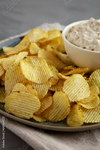 Konstfotografi Crispy Crinkle Potato Chips and French Onion Dip on a Plate, side view