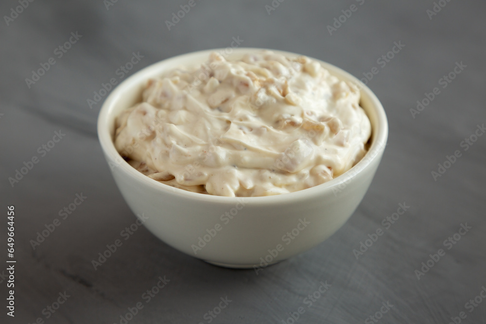 Homemade French Onion Dip in a Bowl on a gray background, side view. Homemade French Onion Dip in a Bowl on a gray background, side view.