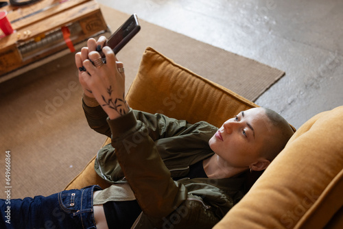 Gen Z female taking a selfie with a smartphone photo