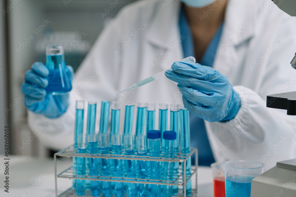 Scientist mixing chemical liquids in the chemistry lab. Researcher working in the chemical laboratory. Scientist mixing chemical liquids in the chemistry lab. Researcher working in the chemical laboratory.