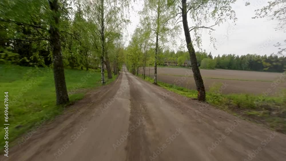 Forward facing view of a car smoothly driving along a stunning country road on a tranquil morning Forward facing view of a car smoothly driving along a stunning country road on a tranquil morning
