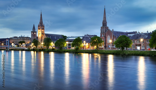The view of the churches of Inverness on the Ness River, Scotland, UK at dramatic sunrise with reflection in water
