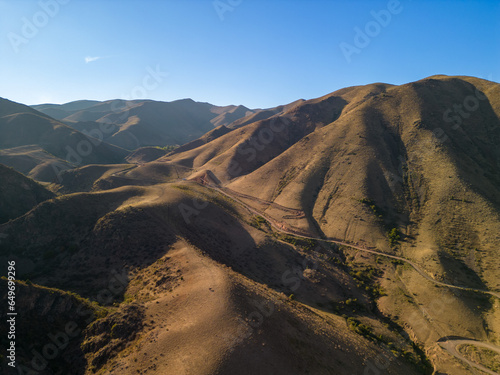 Road between brown hills