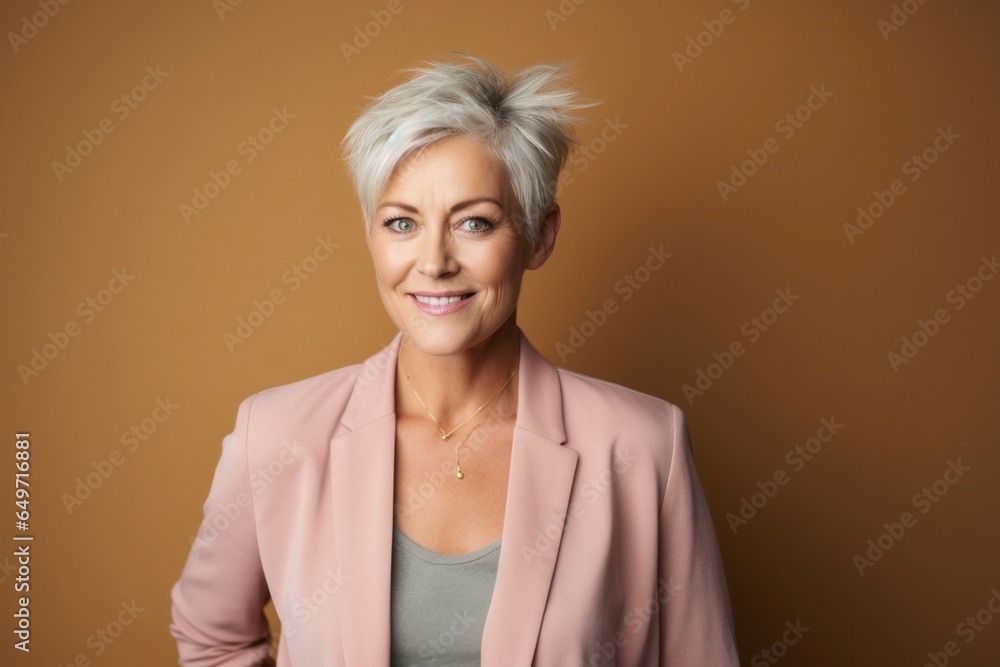 portrait of a Polish woman in her 50s wearing a chic cardigan against an abstract background portrait of a Polish woman in her 50s wearing a chic cardigan against an abstract background