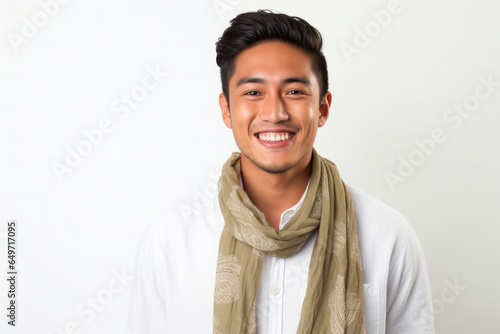 portrait of a confident Filipino man in his 20s wearing a foulard against a white background photo