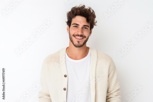 portrait of a confident Israeli man in his 20s wearing a chic cardigan against a white background