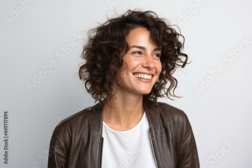 portrait of a confident Israeli woman in her 30s wearing a chic cardigan against a white background