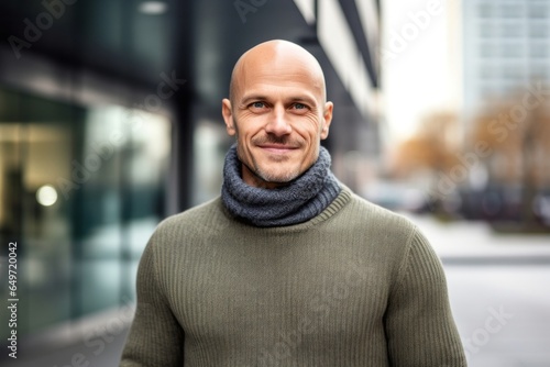 portrait of a confident Polish man in his 40s wearing a cozy sweater against a modern architectural background