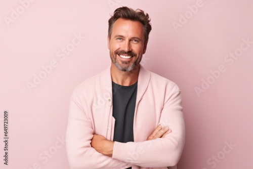 medium shot portrait of a confident Polish man in his 30s wearing a chic cardigan against a pastel or soft colors background © Leon Waltz