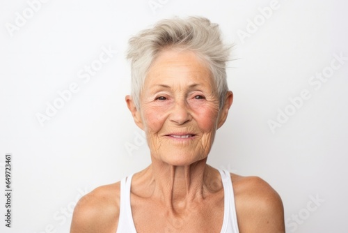 medium shot portrait of a confident Polish woman in her 90s wearing a sporty tank top against a white background