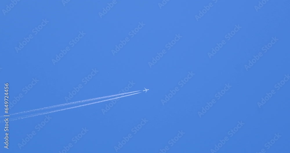 Airplane flying on deep blue sky with chemical direction trails Airplane flying on deep blue sky with chemical direction trails