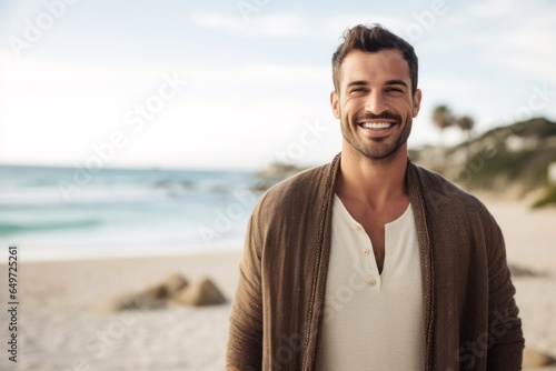 medium shot portrait of a happy Israeli man in his 30s wearing a chic cardigan against a beach background