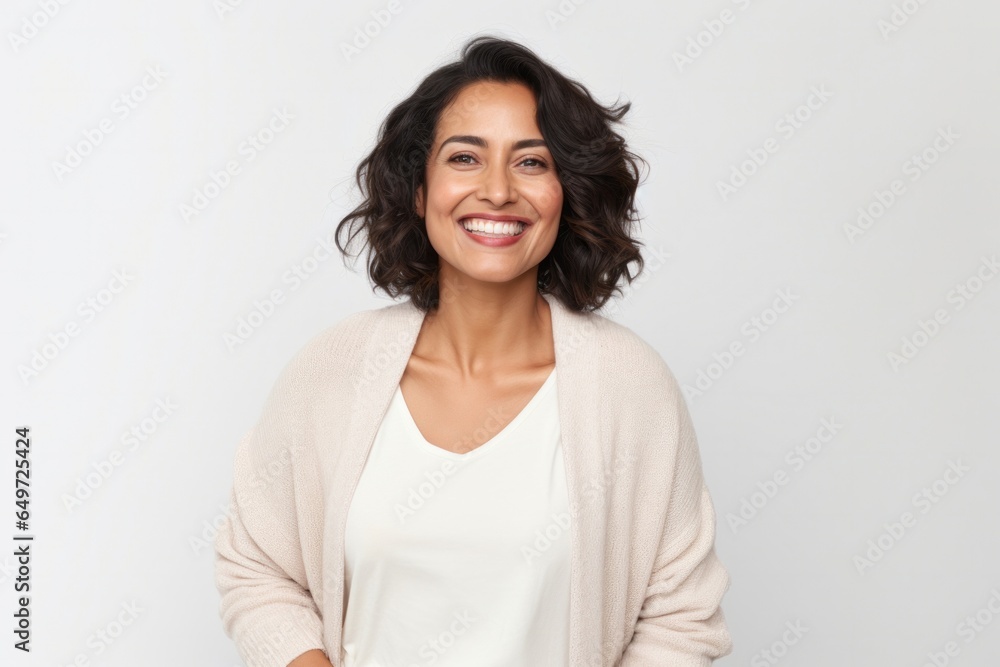 portrait of a happy Mexican woman in her 40s wearing a chic cardigan against a white background portrait of a happy Mexican woman in her 40s wearing a chic cardigan against a white background