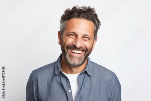 medium shot portrait of a happy Israeli man in his 40s wearing a chic cardigan against a white background