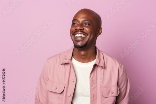 medium shot portrait of a happy Kenyan man in his 40s wearing a chic cardigan against a pastel or soft colors background